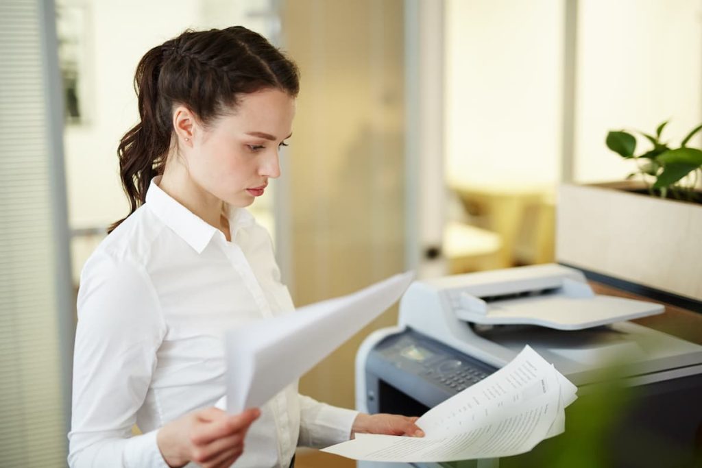 How Many Companies Use Copy Machine Leasing to Stay Ahead of the Curve 9 Copier Lease Agreement. Woman looking at copy machine leasing agreement