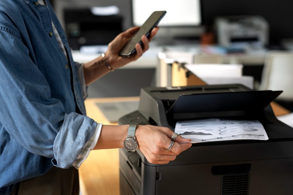 Wireless Printing Solutions: A man is using Wireless printer with mobile phone