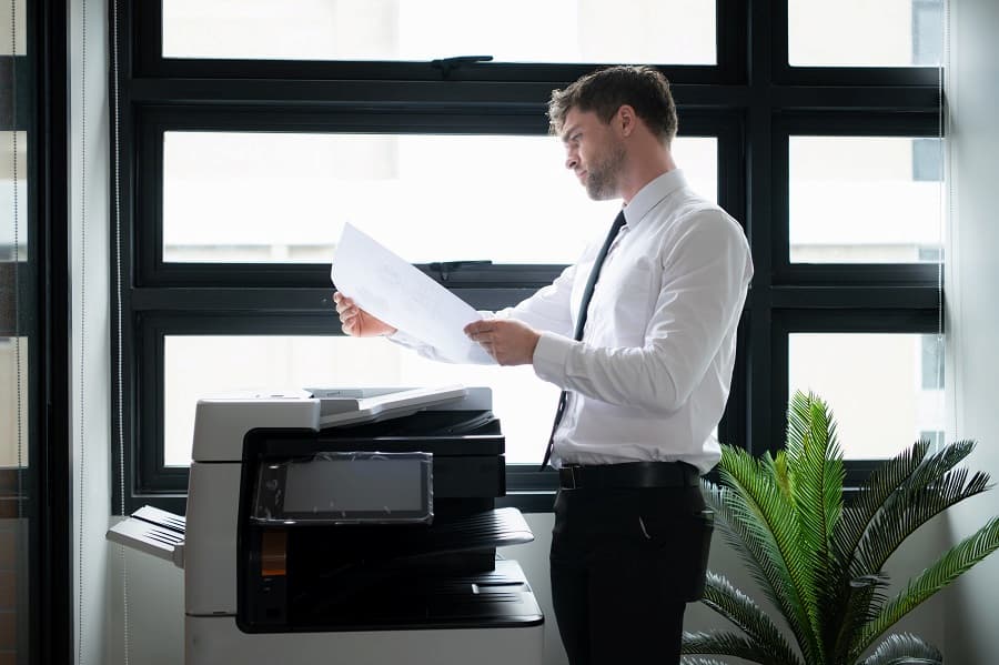 Printer Leasing Costs in Sanford: Types and Maintenance Agreement 10 Man reading and Adjusting the Minimum Number of Pages in the Service Agreement