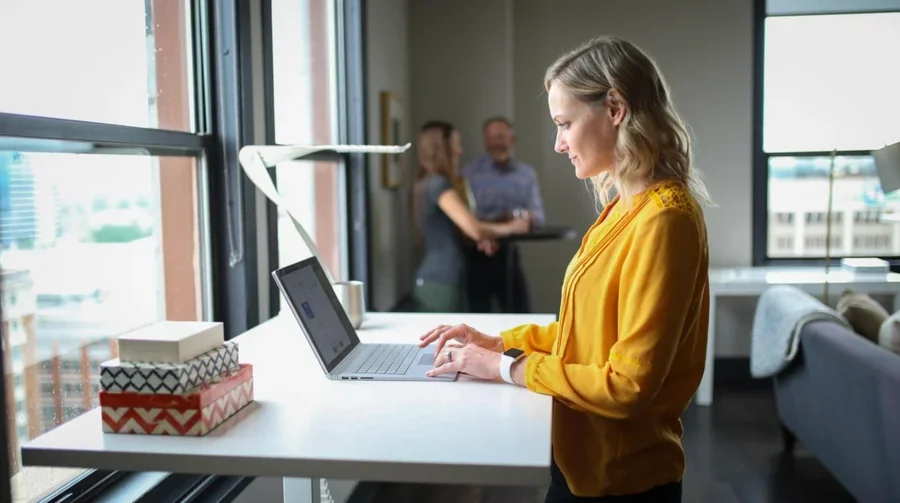 woman standing in front of a laptop